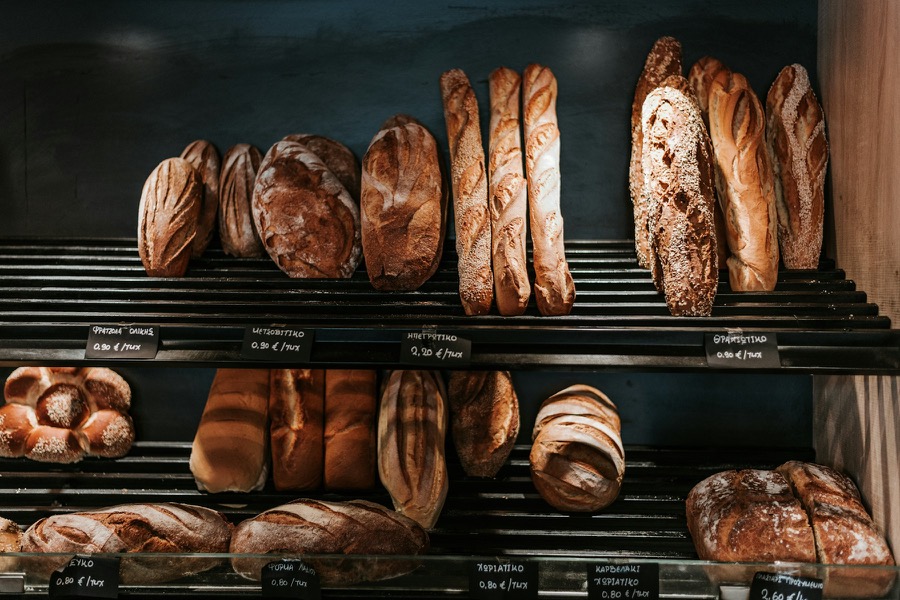 Fresh artisan loaves displayed on bakery shelves